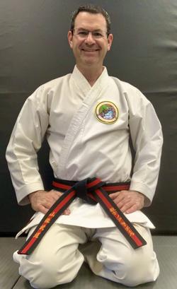 A martial arts instructor smiling
